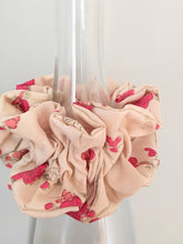 Load image into Gallery viewer, plum blossom scrunchie displayed on the bottle