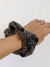 Load image into Gallery viewer, black and white scrunchie on wrist
